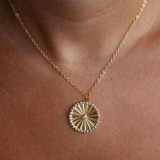 Gold necklace with a circular pendant