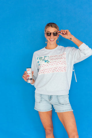 american flag sweatshirt and denim shorts