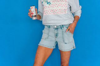 american flag sweatshirt and denim shorts