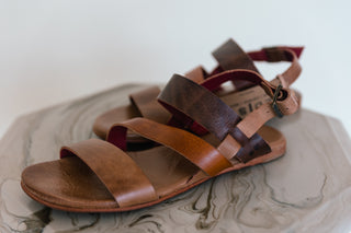 Brown leather sandal on a marble surface