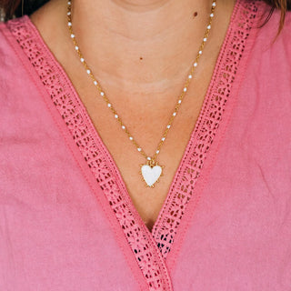 GOLD NECKLACE WITH WHITE BEADS AND A WHITE HEART PENDANT 
