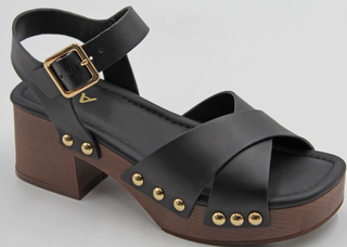 A black leather platform sandal with a brown wooden block heel and platform, decorated with gold-tone metal studs and a buckle strap.