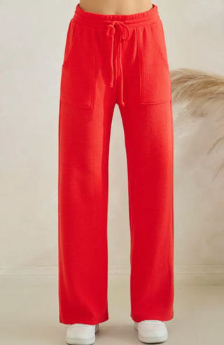 Bright red wide-leg sweatpants with a drawstring waist and side pockets