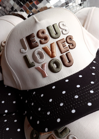 RAISED EMBROIDERY OF JESUS LOVES YOU ON BEIGE HAT WITH BLACK/WHITE POLKA DOTS 