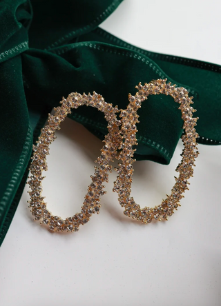 gold-toned hoop earrings covered in small clear rhinestones