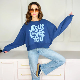 blue sweatshirt with 'Jesus Loves You' text