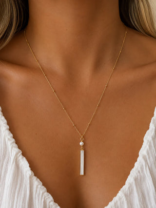 delicate gold chain with long white rectangle pendant and pearl charm 